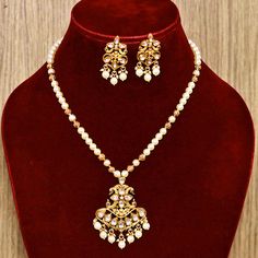 Description: Expertly crafted with designer Kundan stones, this Designer Gold Plated Royal Pendant Set adds a touch of luxury to any outfit. The perfect accessory for special occasions, the set features a intricately designed pendant and matching earrings. Elevate your look and make a statement with this stunning pendant set. About: Eye-catching and unique jewelry that will set you apart. Gift this piece to a loved one, and see their face light up with joy. Best for gifting or for personal use, Traditional Jewelry Sets With Dangling Beads For Celebration, Temple Jewelry Sets With Dangling Beads For Celebrations, Festive Celebration Jewelry Sets With Polished Beads, Festive Jewelry Sets With Dangling Beads For Celebration, Festive Polished Round Bead Jewelry Sets, Elegant Festive Kundan Necklace With Dangling Beads, Elegant Kundan Necklace With Dangling Beads For Festive Season, Traditional White Jewelry Sets With Polished Beads, Elegant Jewelry Sets With Round Beads For Diwali