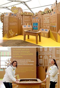 two women are standing in front of a cardboard box with buildings on it and the words solarra geneve