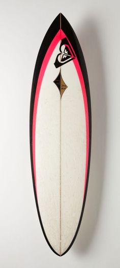 a surfboard hanging on the wall with a black and red stripe around it's edge