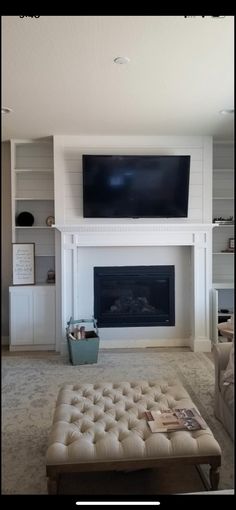 a large flat screen tv mounted above a fireplace