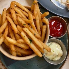 french fries and dips on a blue plate