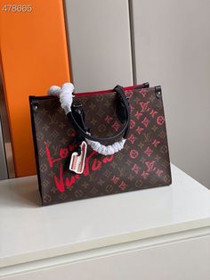 Description L.V Onthego MM Fall In Love Monogram Heart Tote Bag Brown For Women 35cm LV Rep 1:1 Size: 35 x 27 x 14 cm (Length x height x width ) This bag is made from monogram canvas with monogram flowers and heart in red and pink, the OnTheGo MM tote bag is signed “L.V” in lipstick as part of the Fall In Love capsule collection. A lipstick charm completes the picture. The OnTheGo has both long and short handles to enable comfortable hand and shoulder carry. Brown Monogram Double handle Include Onthego Mm, Louis Vuitton Onthego, Heart Tote Bag, Monogram Hearts, Louis Vuitton Shirt, Louis Vuitton Neverfull Mm, Stylish Handbags, Handbags Tote, Luxury Products