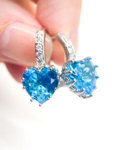 Perfect Earrings for a summer wedding!! Stunning Sparkly Turquoise blue Crystal Heart Earrings, Sterling silver! Swarovski Heart Crystal 10mmX10mm Three 1.5mm CZ accents  Latch back huggie style Drop length approx 20mm I love working with Swarovski Crystals!! They are the sparkliest gem aside from Diamonds of course :) I'm excited to share new designs for this new Spring/summer season! it will be great to have sparkly gorgeous earrings to pair with your outfit!  Thank you for looking! Lisa Pleas Bridal Jewelery, Crystal Heart Earrings, Swarovski Heart, Heart Shaped Jewelry, Heart Drop Earrings, Bride Jewellery, Crystal Heart, Gorgeous Earrings, Blue Crystals