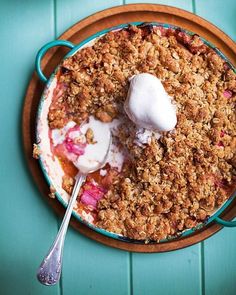 a dish with some ice cream on top of it next to a fork and spoon