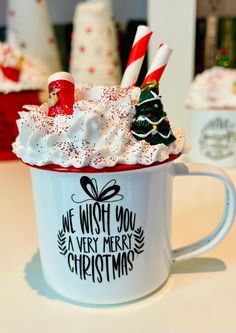 a cup filled with whipped cream and candy canes