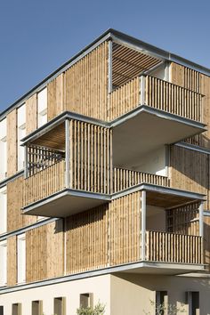 an apartment building with wooden balconies on the sides