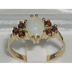 an opal and garnetia ring in yellow gold plated silver with red stones