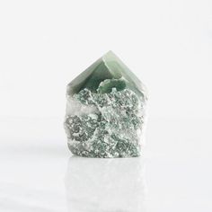 a green and white rock sitting on top of a table