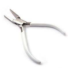 a white pair of scissors on a white background with clippings to the side