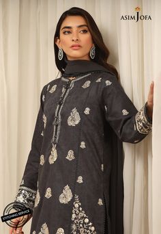 FABRIC: SELF-JACQUARDCOLOR: CHARCOAL GREY A traditionally rich composition is aptly portrayed on this appealing cotton ensemble rendered in a captivating charcoal grey shade. This beautiful shirt is paired with a cambric trouser and a chiffon dupatta. A heritage rich outfit that is a fashion statement to embrace at festive events.DESIGN DETAILS:1 Embroidered Center panel for Front on Self-Jacquard1 Embroidered Neckline on Self-Jacquard2 Embroidered Side Panels for Front on Self-Jacquard (Right a Elegant Cotton Tops With Printed Motifs, Black Cotton Tops For Eid, Fitted Cotton Gray Set, Fitted Gray Cotton Set, Festive Gray Long Sleeve Sets, Black Cambric Traditional Wear With Long Sleeves, Black Cambric Long Sleeve Traditional Wear, Traditional Gray Embroidered Sets, Gray Chikankari Embroidery Traditional Sets