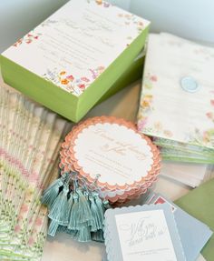 the wedding stationery is laid out on top of each other, including cards and envelopes