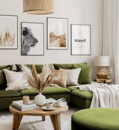 a living room with green couches and pictures on the wall above them, along with a coffee table