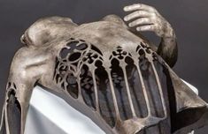 a sculpture of a human body is shown with its hands on it's back