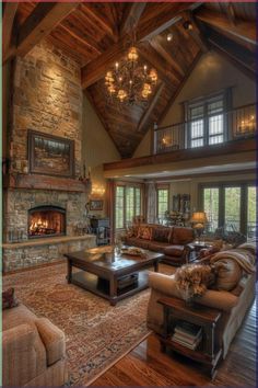 a living room filled with lots of furniture and a fire place in the middle of it