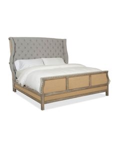 a bed with an upholstered headboard and foot board on top of it