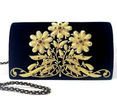 "Luxury black velvet evening clutch bag, expertly hand embroidered with gold flowers and embellished with genuine semi precious stones, to create an opulent, sophisticated 3D effect. Add an eye-catching pop of color, texture and sparkly bling to your overall party look. It is just the right size to hold your essentials for the night - phone, credit cards, money, keys and lipstick. The shoulder strap keeps your hands free for carrying a drink or holding a plate of food. Or twist the shoulder stra Holding A Plate, Statement Clutch Bag, Plate Of Food, Statement Handbag, Unique Handbags, Embroidered Handbag, Velvet Clutch, Floral Clutches, Wedding Clutch