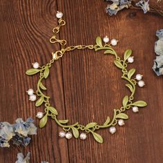 Elevate your elegance with our exquisite Lily of the Valley Bracelet, a piece that exudes the delicate charm and profound symbolism of this beloved bloom. The Lily of the Valley, known for its sweet fragrance and bell-shaped flowers, symbolizes humility, happiness, and renewal. This bracelet not only celebrates the natural beauty of these delicate flowers but also carries their deep symbolic meaning, making it a perfect piece for those who appreciate both elegance and sentiment. Discover the enchanting beauty of nature with our exquisite Lily of the Valley Bracelet, and let it enhance your elegance and style. DETAILS Plating: 18K Gold Materials: 18K Gold on Brass, Freshwater Pearl, Enamel Measurements: Length: 6.69"(17cm) + Extender: 2.76"(7cm) Weight: 12g There will be a little difference Elegant Green Bracelet With Flower Charm, Lily Of The Valley Flowers, Sweet Fragrance, Delicate Flowers, Nature Inspired Jewelry, Sweet Fragrances, Brass Charms, Nature Bracelets, Delicate Flower