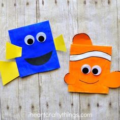 an orange and blue paper bag sitting next to each other on top of a wooden table