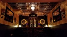 an ornately decorated dining room with chairs and lights on the ceiling is lit up