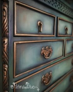 an antique dresser with ornate handles and knobs on it's drawers, painted in blue