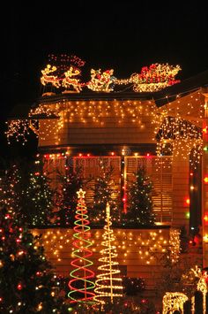 a house covered in christmas lights at night