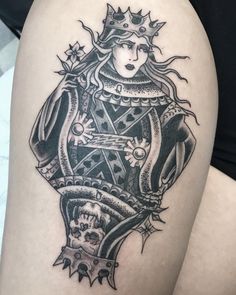 a woman's thigh with a tattoo design on her leg and an image of a crown