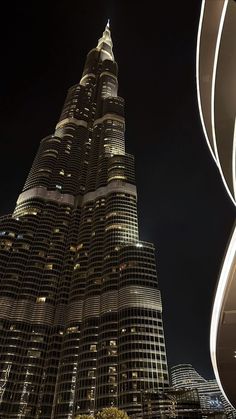 the burj building is lit up at night