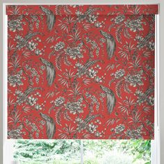 a red roman blind with an image of birds and flowers on it in front of a window