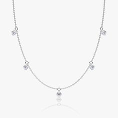 The Floating Station Necklace features a series of ¼ carat Round Brilliant VRAI created diamonds that gently dangle from their pierced-diamond settings. Classic White Gold Dangle Necklace, Brilliant Cut Diamond Dangle Jewelry, Classic Cubic Zirconia Dangle Necklaces, Classic Dangle Cubic Zirconia Necklaces, Anniversary Dangle Diamond Necklace, Fine Jewelry Diamond Dangle Necklace With Accents, White Gold Diamond Dangle Necklaces, Dazzling Diamond Dangle Necklace, Diamond Dangle Necklace