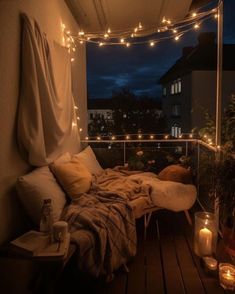 a bed sitting on top of a wooden floor next to a window covered in lights