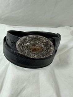 "You are looking at genuine lizard belt with sterling silver buckle. Belt measures 37\"72 long with 29\"4 from the first perforation and 34\"4 at its last perforation from buckle and 1\"1 width. The front buckle measures approximately 2\"7 x 1\"6 and has lovely patina. The lizard belt and buckle is a great vintage find and will last you for years to come.  Shipping Shipping is done with USPS priority mail within the U.S. and shipping takes 4-5 business days from the date of payment. Please note I do combine shipping for multiple items." Western Engraved Belt For Formal Occasions, Western Style Engraved Belt For Formal Occasions, Vintage Formal Belts With Silver Buckle, Formal Adjustable Engraved Belt, Western Silver Belt With Antique Buckle, Vintage Silver Leather Belt Buckles, Vintage Adjustable Belt Buckles For Formal Wear, Silver Western Belt For Formal Occasion, Western Style Silver Belt For Formal Occasions