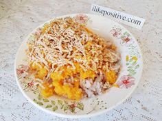 a white plate topped with lots of food on top of a lace covered table cloth