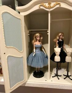 two barbie dolls are standing in a closet