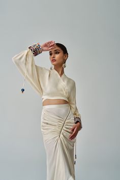 Asymmetric Cocktail Skirt With Zip Detailing And Side Tie Up Materials used: Habutai Color: Ivory Product care: Dry clean only Luxury Cream Traditional Drape Blouse Piece, Traditional Fitted Draped Blouse, Ceremonial Traditional Drape Blouse, Festive Hand-embellished Traditional Drape Blouse, Diwali Embellished Draped Blouse, Draped Skirt Outfit, Long Skirt Ideas, Ethnic Wear Women, Indian Skirts