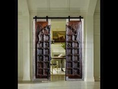 an open door in the middle of a room with white walls and marble flooring