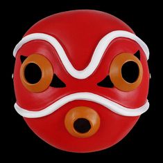 a red and white mask with two orange eyes