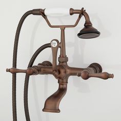 an old fashioned faucet with two hoses attached to the side of it