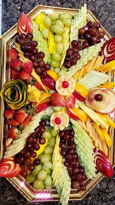 a platter filled with lots of different types of fruit