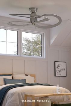 a bedroom with white walls and ceiling fan