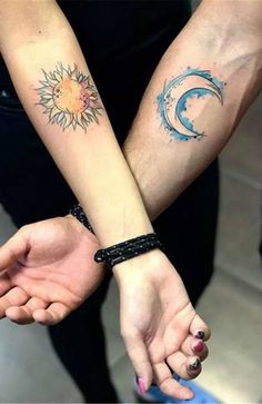 two people holding hands with sun and moon tattoos on their arms, both showing the same time