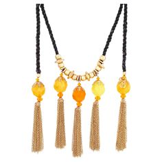 - Vintage item - Collectible costume jewelry piece from the '80s - Extremely rare, hard to find style - 70" length - 6" tassel drop - Gold plated hardware - Twisted black silk cord - Orange and yellow marbled faceted resin beads - Gold chain tassel - Can be worn as a necklace or belt - By Christian Lacroix (signed on hang tag) - Made in Paris, France - Circa 1980s - Estate acquired - Beautiful vintage condition with light fraying to silk cord (see photos) Silk Cord Necklace, Resin Chain, Orange Sapphire, Silk Cord, Star Jewelry, Pearl Strands, Rope Necklace, Resin Beads, Christian Lacroix