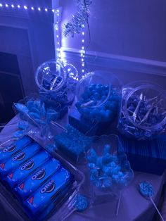 a table topped with lots of blue candies