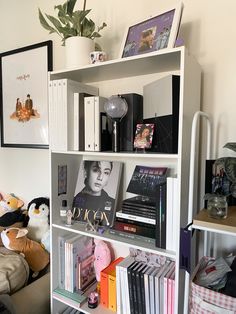 a bookshelf filled with lots of books next to a couch