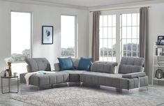 a grey sectional sofa with blue pillows in a living room