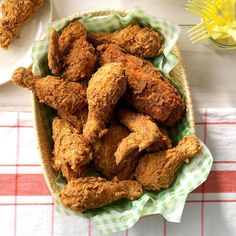 a basket full of fried chicken sitting on top of a table