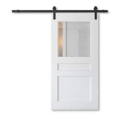 a white door with a black metal frame and glass paneling on the front side