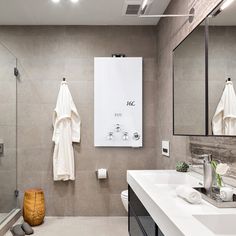 a bathroom with two white towels hanging on the wall