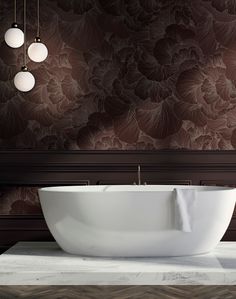 a large white bathtub sitting on top of a counter next to two lights hanging from the ceiling