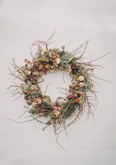 a wreath made out of branches and flowers