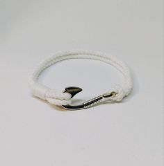 This is beautiful stylish minimalist rope bracelet, fish hook bracelet, knot cotton cord nautical bracelet for men and women, teens, summer beach bracelet, sailor knot rope bracelet, nautical wedding favor, turk head knot, friendship bracelet. This bracelet is made by hand from natural cotton rope. These bracelets will be a good gift for your friends at a sea beach party, a nautical wedding. Please select your color: 1. White 2. Ivory 3. Black 4 Blue 5. Dark blue WHOLESALE is welcome.  If you wa White Adjustable Nylon Cord Jewelry, White Braided Bracelets With Sliding Knot For Summer, White Braided Bracelets For Everyday Summer Wear, White Braided Bracelet With Sliding Knot For Summer, White Nautical Style Bracelet Gift, Casual White Jewelry With Nylon Cord, White Nylon Cord Bracelets For Beach, White Braided Bracelets With Sliding Knot Nylon Cord, Minimalist White Braided Bracelets For Everyday Use